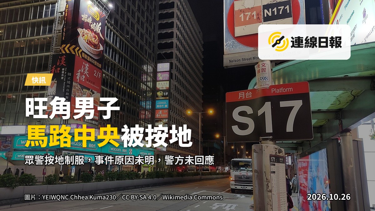 旺角十字路口，多名軍裝警員喺行人路旁拉起警察封鎖線，圍住一名坐喺地上嘅男子，背景係貼滿廣告海報嘅牆壁，馬路中央有黃色格仔。